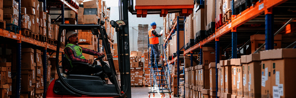 a forklift in a warehouse full of boxes