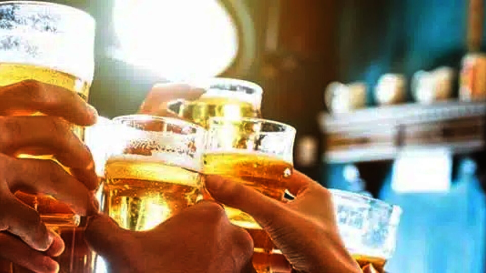 Hands holding beers coming together in the air