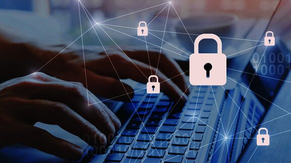 Hands typing on a keyboard with digital padlock icons, symbolizing online security and data protection