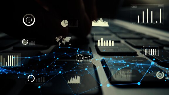 Fingers typing with overlaid digital graphs and networks, symbolizing data analysis and technology