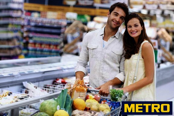 young couple in the supermarket with their supermarket trolley