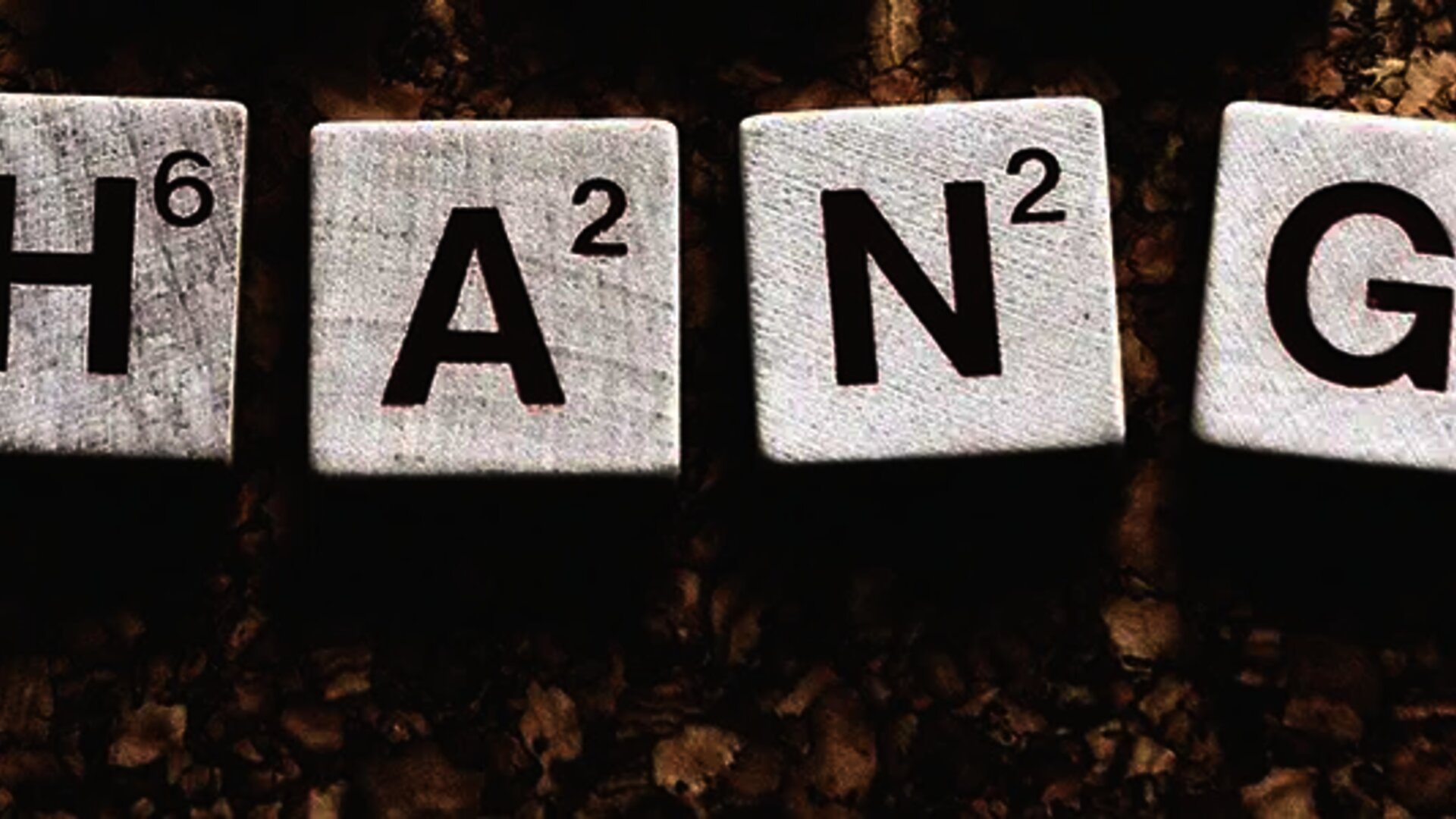 CHANGE' spelled with wooden Scrabble tiles on a corkboard background