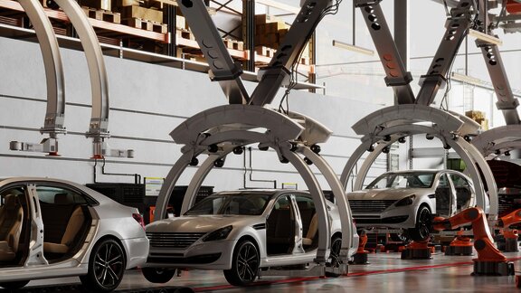 Robotic arms assembling cars on a production line, showcasing advanced manufacturing technology