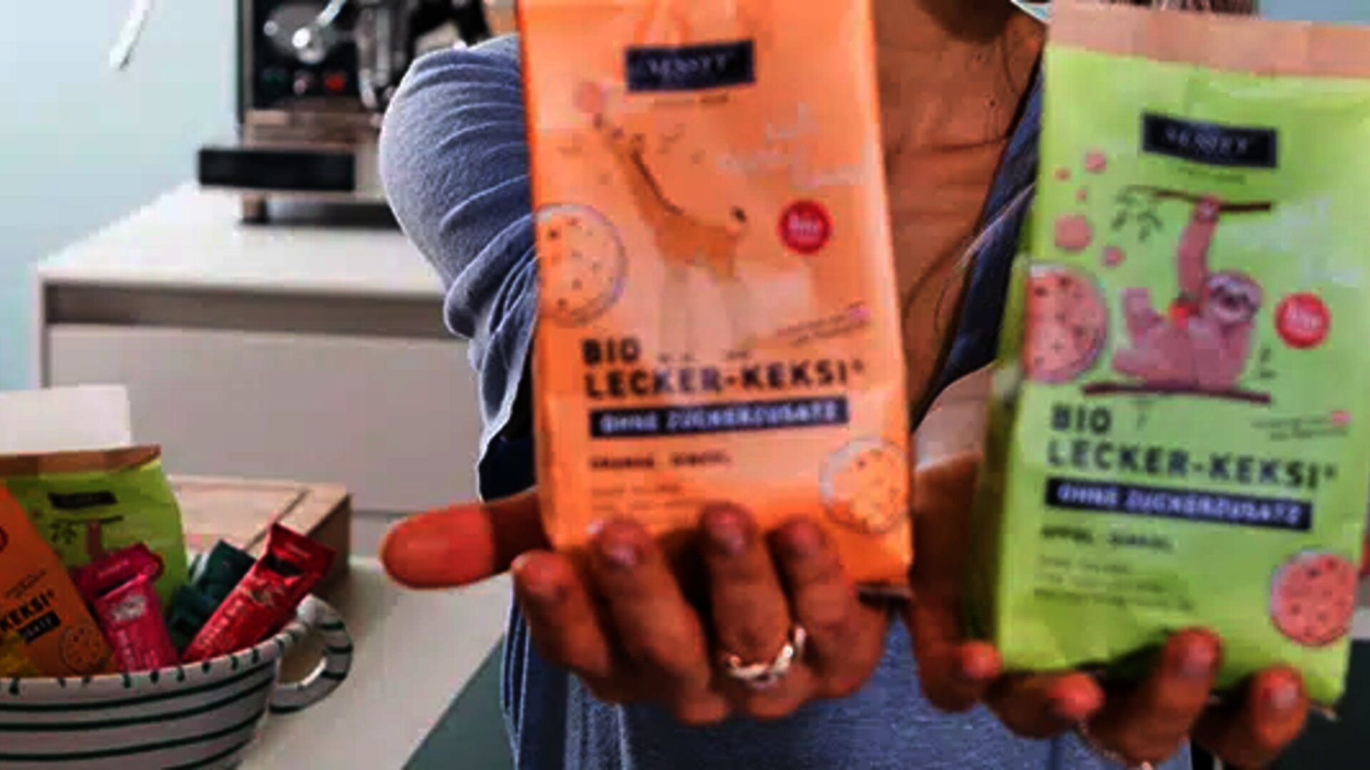 EDI Services for Nussyy: Young woman holds two packets of muesli in her hand