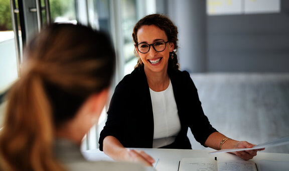 Shot of two businesswomen shaking hands in a modern office