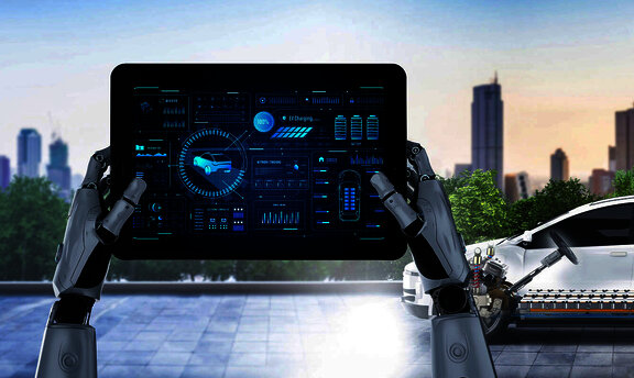 tablet v ruk&aacute;ch robota s autom v pozad&iacute;