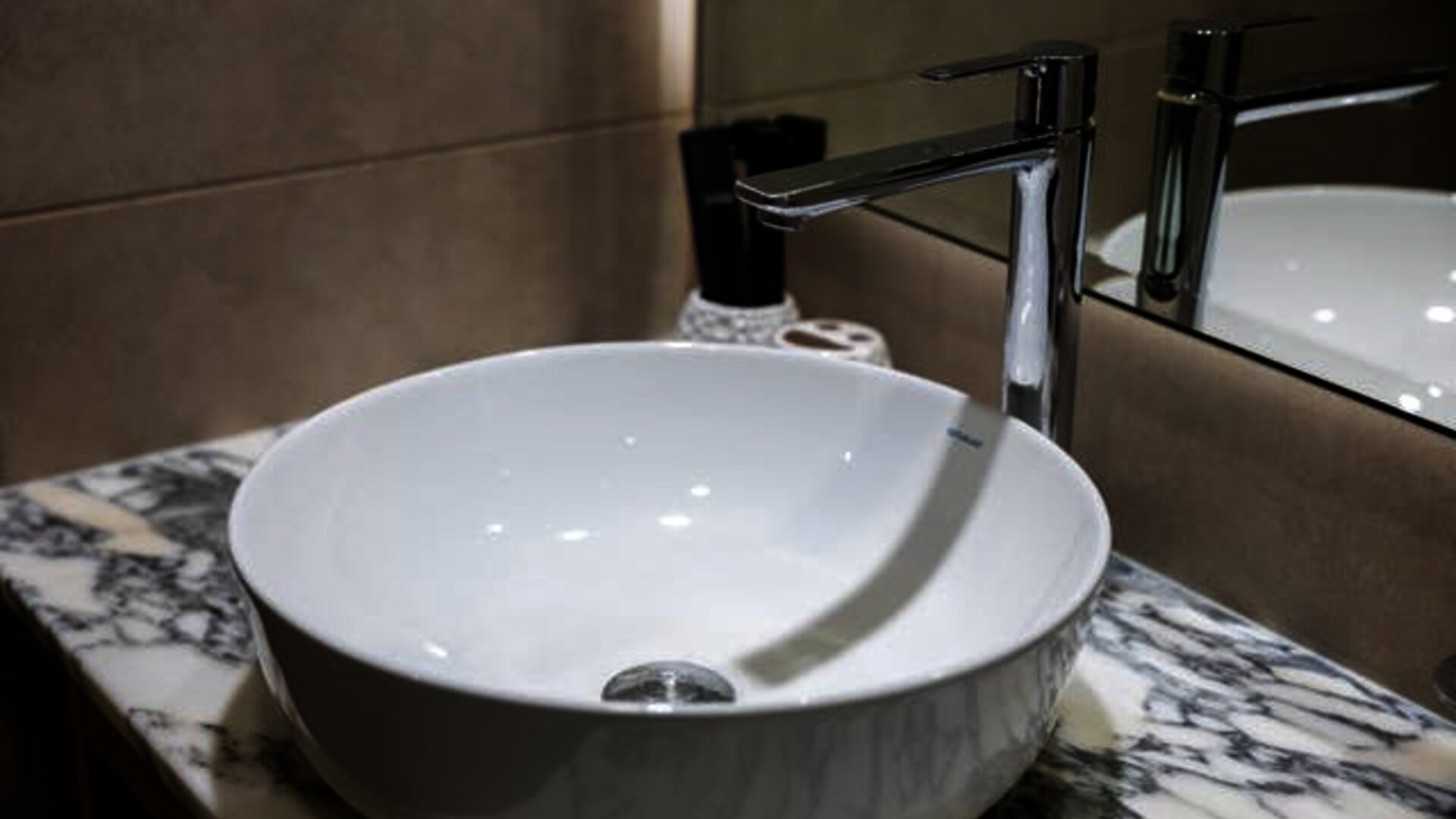 A white circular bathroom sink