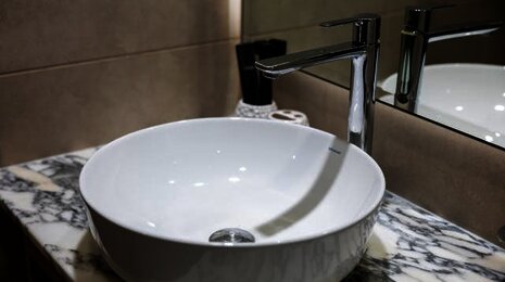 A white circular bathroom sink
