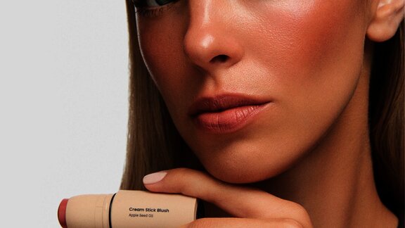 woman holding a blush stick in her hand