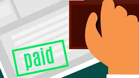 Hand stamping a document with 'PAID
