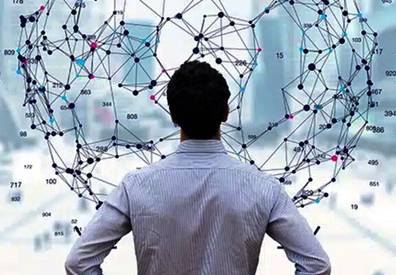 Man standing in front of a digital interface displaying a network of global connections and data analysis icons